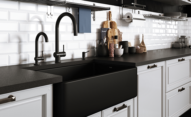 A black kitchen faucet paired with black kitchen accessories in a black-and-white kitchen.